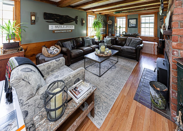 2103 US Highway 1, Sullivan, ME 04664 - living room with hardwood / wood-style flooring, wainscoting, beam ceiling, and wooden walls