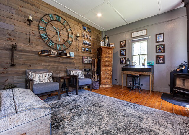 2103 US Highway 1, Sullivan, ME 04664 - living area with a wood stove, hardwood / wood-style floors, wooden walls, and recessed lighting