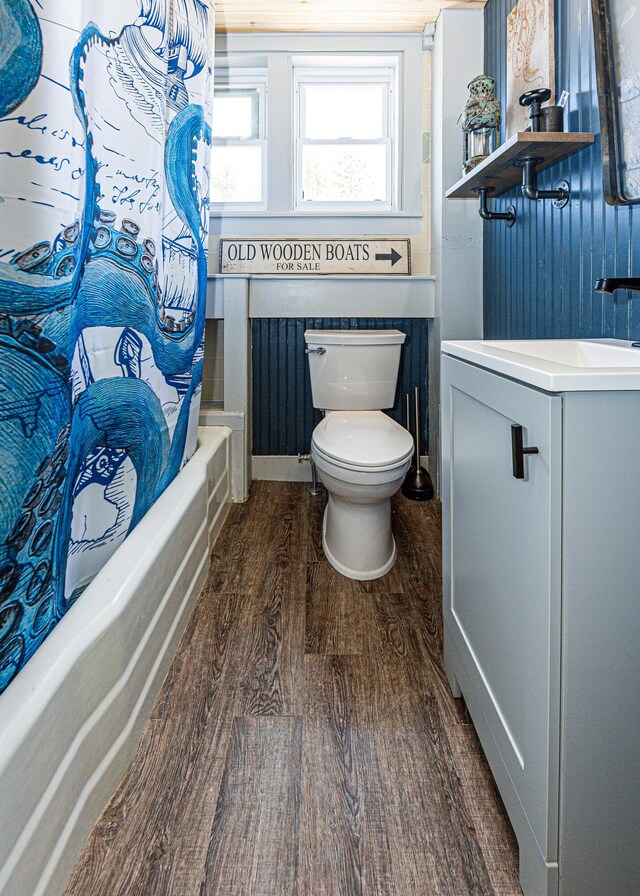 2103 US Highway 1, Sullivan, ME 04664 - bathroom featuring wood finished floors, toilet, shower / tub combo with curtain, and vanity