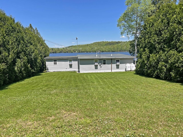 861 W Shore Rd, Otis, ME 04605 - rear view of house featuring a lawn