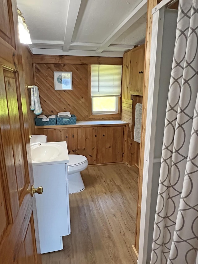861 W Shore Rd, Otis, ME 04605 - full bathroom featuring wooden walls, vanity, toilet, wood finished floors, and beam ceiling