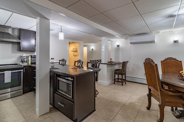 231 Parkway S, Brewer, ME 04412 - kitchen with stainless steel appliances, a wall unit AC, wall chimney exhaust hood, a baseboard radiator, and light tile patterned flooring