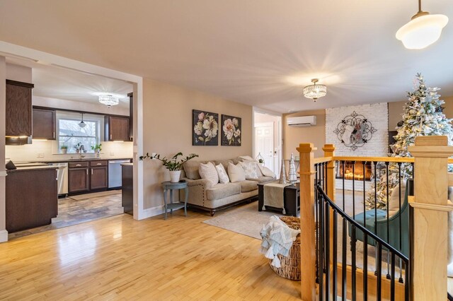 231 Parkway S, Brewer, ME 04412 - living room featuring a wall mounted AC, light wood-style floors, and baseboards