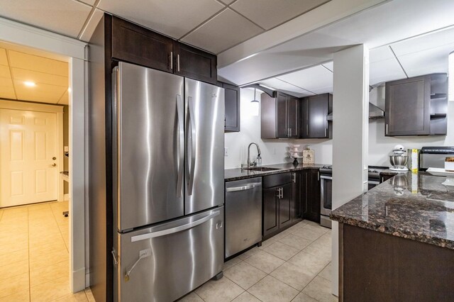231 Parkway S, Brewer, ME 04412 - kitchen with stainless steel appliances, a sink, light tile patterned floors, dark brown cabinetry, and a drop ceiling