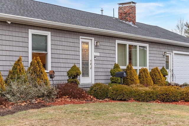 231 Parkway S, Brewer, ME 04412 - property entrance featuring a chimney, roof with shingles, and a lawn
