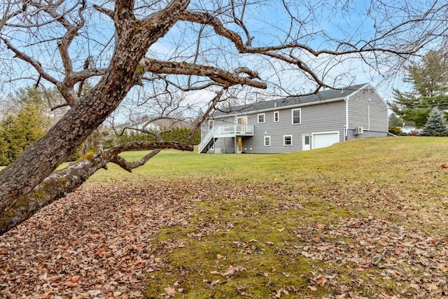 231 Parkway S, Brewer, ME 04412 - view of green lawn with stairway, an attached garage, and a wooden deck