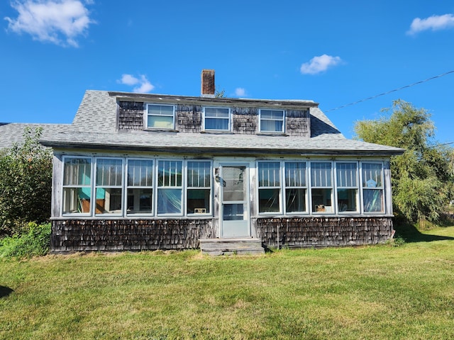 1542 Moosehead Trail Highway, Plymouth, ME 04969 - view of front of home with a sunroom, a chimney, a front yard, and a shingled roof