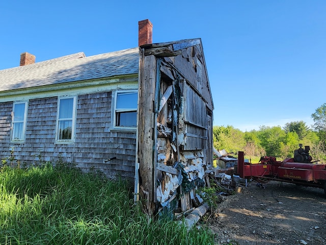 1542 Moosehead Trail Highway, Plymouth, ME 04969 - view of property exterior with a chimney and roof with shingles