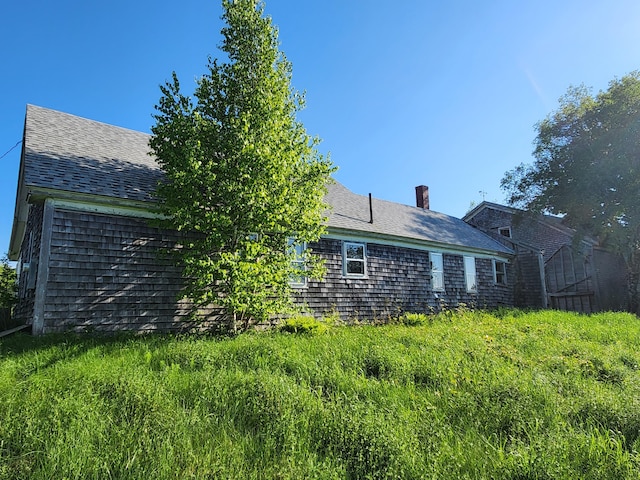 1542 Moosehead Trail Highway, Plymouth, ME 04969 - back of house featuring roof with shingles and a chimney
