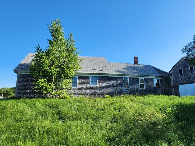 1542 Moosehead Trail Highway, Plymouth, ME 04969 - back of house featuring a chimney and a shingled roof