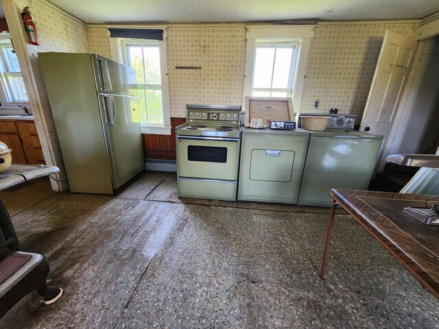 1542 Moosehead Trail Highway, Plymouth, ME 04969 - kitchen featuring white electric range, freestanding refrigerator, washing machine and clothes dryer, wallpapered walls, and a sink