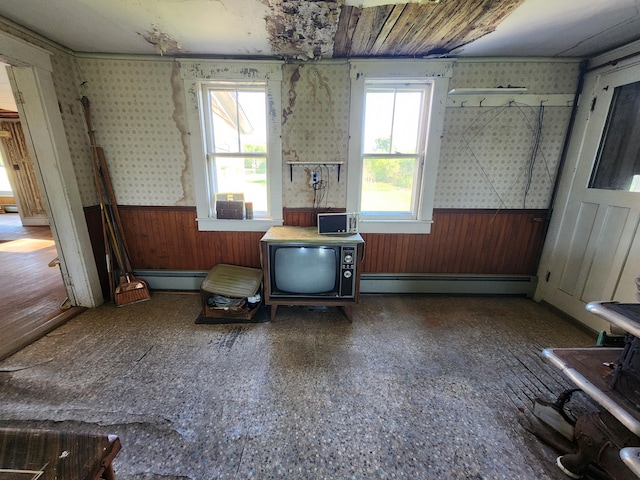 1542 Moosehead Trail Highway, Plymouth, ME 04969 - miscellaneous room with a baseboard radiator, wainscoting, wallpapered walls, and wooden walls
