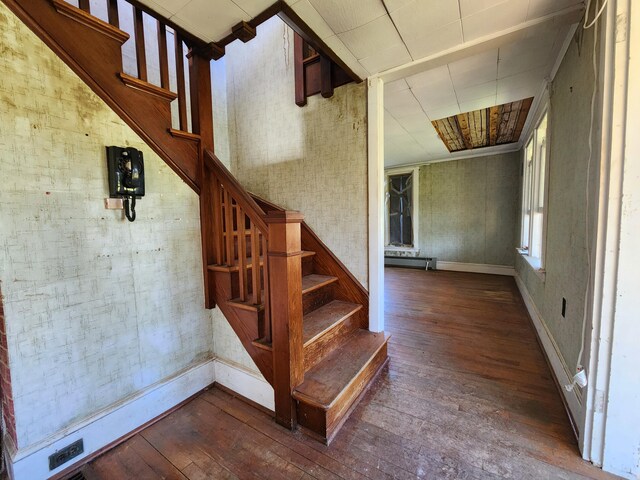 1542 Moosehead Trail Highway, Plymouth, ME 04969 - staircase featuring hardwood / wood-style floors, a baseboard heating unit, and baseboards