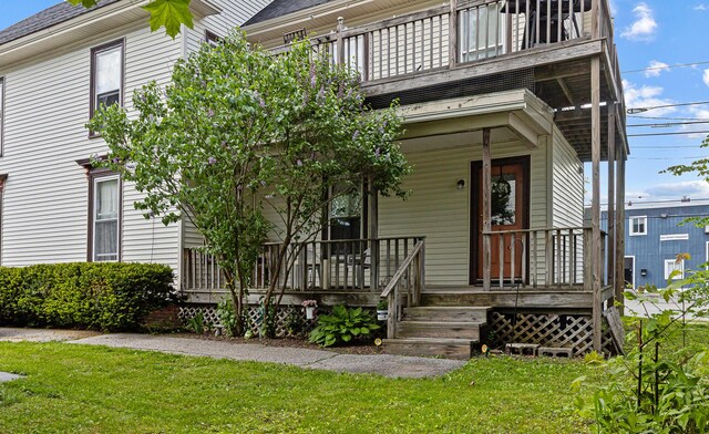 151 Birch St Unit A, B, Bangor, ME 04401 - view of front facade with a balcony, covered porch, a front yard, and a shingled roof