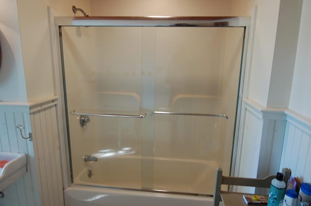 14 Auditorium Park, Northport, ME 04849 - full bathroom with enclosed tub / shower combo, a decorative wall, and a wainscoted wall