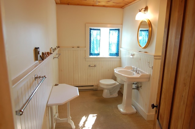 14 Auditorium Park, Northport, ME 04849 - half bathroom with wainscoting, baseboard heating, toilet, and wood ceiling
