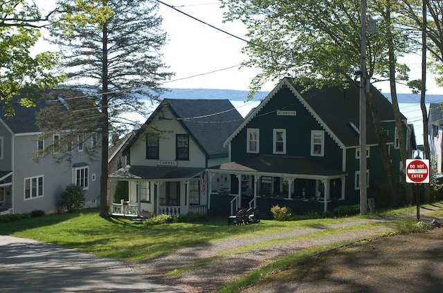 14 Auditorium Park, Northport, ME 04849 - victorian-style house with covered porch and a front yard