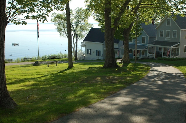 14 Auditorium Park, Northport, ME 04849 - view of front of home with a water view, a front lawn, and asphalt driveway