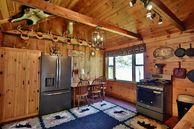 50 Hook Ln, Frenchtown Twp, ME 04441 - kitchen featuring appliances with stainless steel finishes, wood ceiling, wooden walls, and a chandelier
