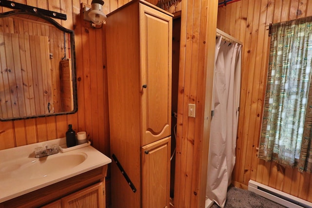 50 Hook Ln, Frenchtown Twp, ME 04441 - bathroom featuring wood walls, a baseboard heating unit, and vanity
