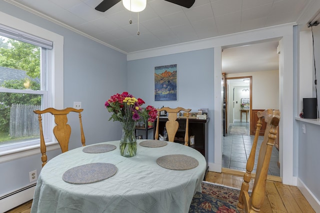 52 Pleasant St, North Berwick, ME 03906 - dining room featuring a baseboard heating unit, a ceiling fan, ornamental molding, hardwood / wood-style floors, and baseboards