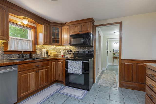52 Pleasant St, North Berwick, ME 03906 - kitchen featuring black appliances, a sink, tasteful backsplash, dark countertops, and a wainscoted wall