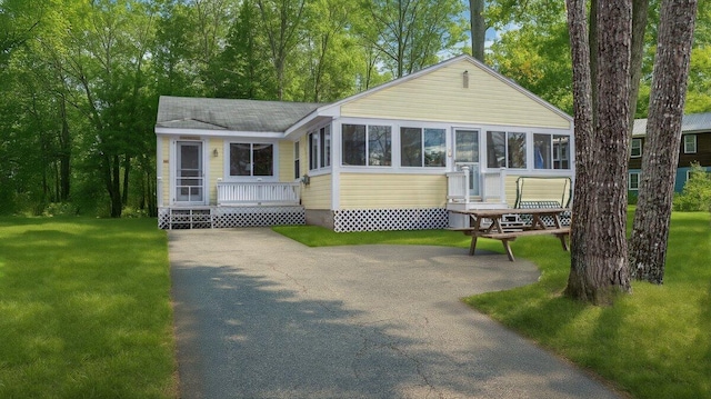 18 Scenic View Dr, Naples, ME 04055 - view of front of property with a sunroom and a front yard