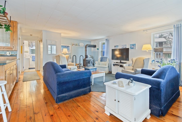 18 Scenic View Dr, Naples, ME 04055 - living area with a wood stove, plenty of natural light, and light wood-style floors