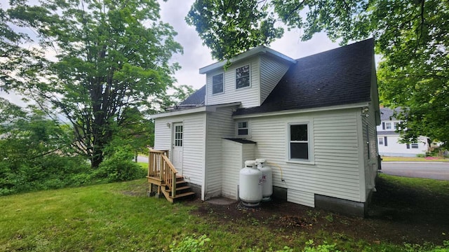 14 Highland Ave, Augusta, ME 04330 - back of property with a lawn and a shingled roof