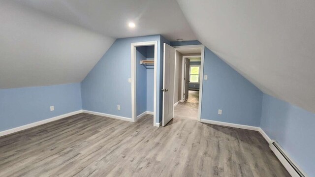 14 Highland Ave, Augusta, ME 04330 - bonus room featuring a baseboard heating unit, lofted ceiling, wood finished floors, and baseboards