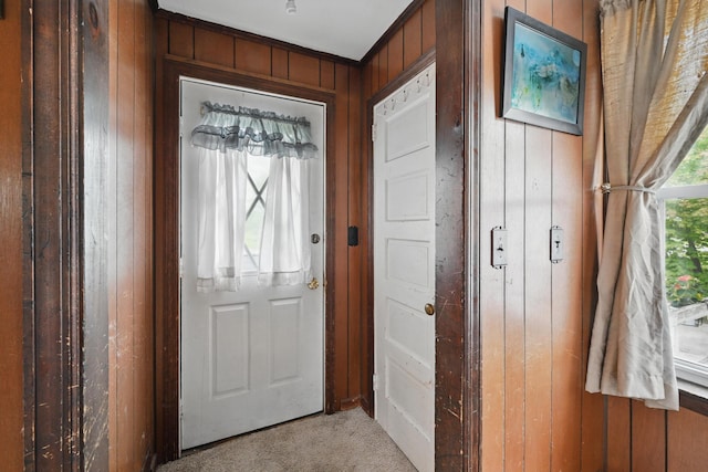 383 Main St, Pittsfield, ME 04967 - doorway to outside featuring light carpet and wood walls