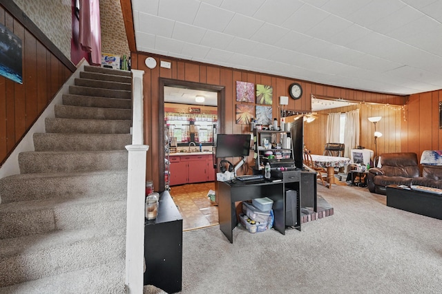 383 Main St, Pittsfield, ME 04967 - living area with wooden walls, stairway, and carpet floors