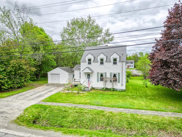 383 Main St, Pittsfield, ME 04967 - new england style home with an outdoor structure, a detached garage, asphalt driveway, and a front yard