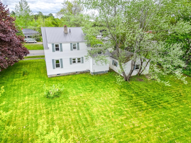383 Main St, Pittsfield, ME 04967 - rear view of property featuring a chimney, a yard, and metal roof
