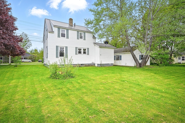 383 Main St, Pittsfield, ME 04967 - rear view of house with a chimney, a lawn, and metal roof