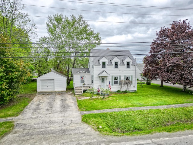 383 Main St, Pittsfield, ME 04967 - cape cod house with an outdoor structure, a detached garage, driveway, a front lawn, and a gambrel roof