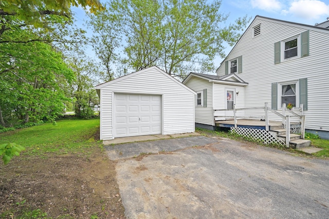 383 Main St, Pittsfield, ME 04967 - view of front of property with an outdoor structure, a garage, asphalt driveway, and a wooden deck