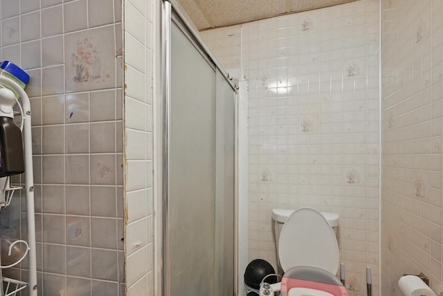 383 Main St, Pittsfield, ME 04967 - full bath featuring toilet, a shower stall, and tile walls