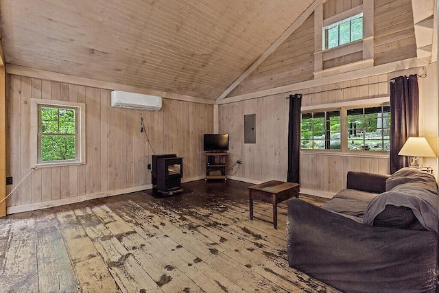 16 Trillium Ests, Rome, ME 04963 - living room with a wood stove, hardwood / wood-style floors, an AC wall unit, electric panel, and plenty of natural light
