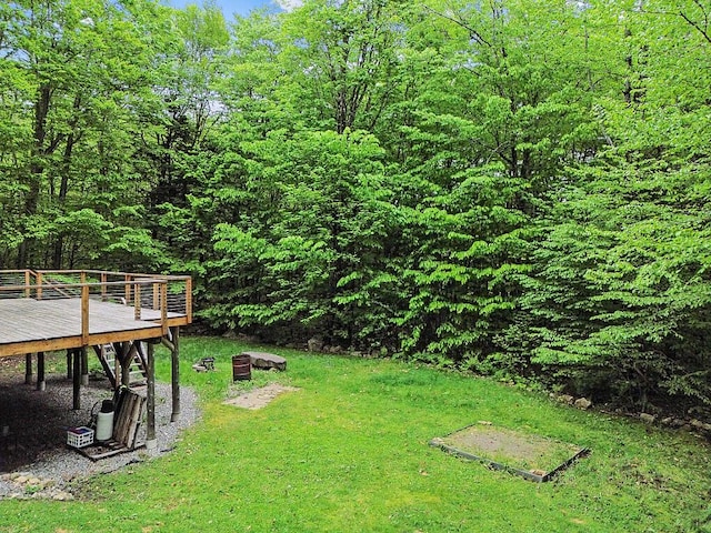 16 Trillium Ests, Rome, ME 04963 - view of grassy yard featuring a deck and a view of trees