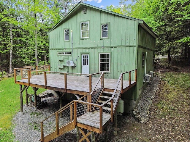 16 Trillium Ests, Rome, ME 04963 - rear view of house featuring board and batten siding, a deck, stairway, and cooling unit