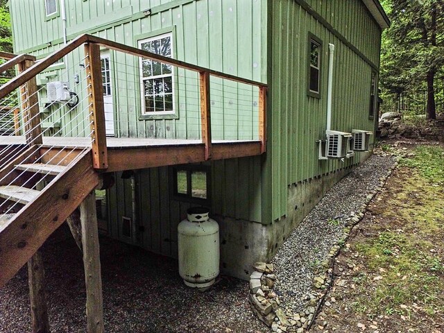 16 Trillium Ests, Rome, ME 04963 - view of side of home featuring board and batten siding, stairway, and cooling unit