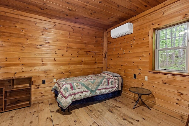 16 Trillium Ests, Rome, ME 04963 - bedroom with a wall mounted AC, light wood-type flooring, wooden ceiling, and wood walls