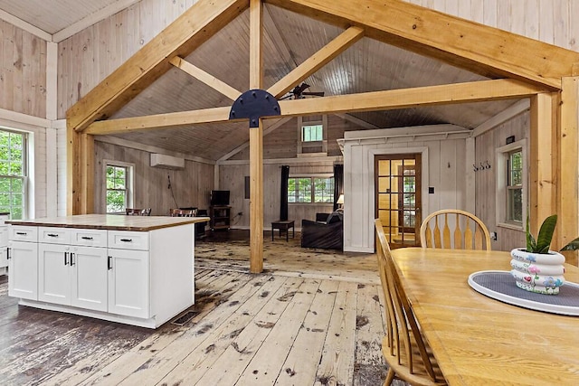 16 Trillium Ests, Rome, ME 04963 - kitchen with butcher block countertops, wood walls, light wood-type flooring, white cabinetry, and an AC wall unit
