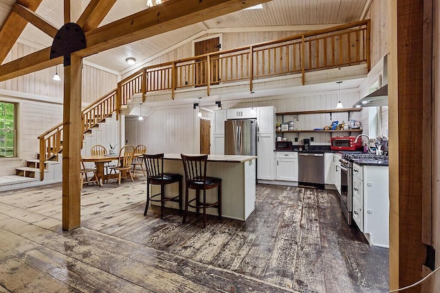16 Trillium Ests, Rome, ME 04963 - kitchen featuring appliances with stainless steel finishes, open shelves, dark wood-style flooring, dark countertops, and a kitchen island