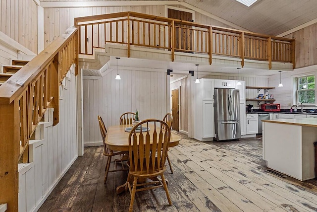 16 Trillium Ests, Rome, ME 04963 - dining area with hardwood / wood-style floors, wood walls, stairs, and high vaulted ceiling