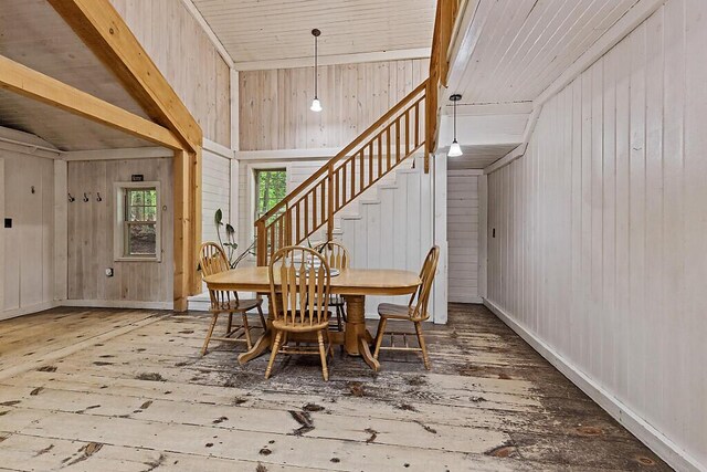 16 Trillium Ests, Rome, ME 04963 - dining space with wood-type flooring, wood walls, lofted ceiling, stairway, and baseboards