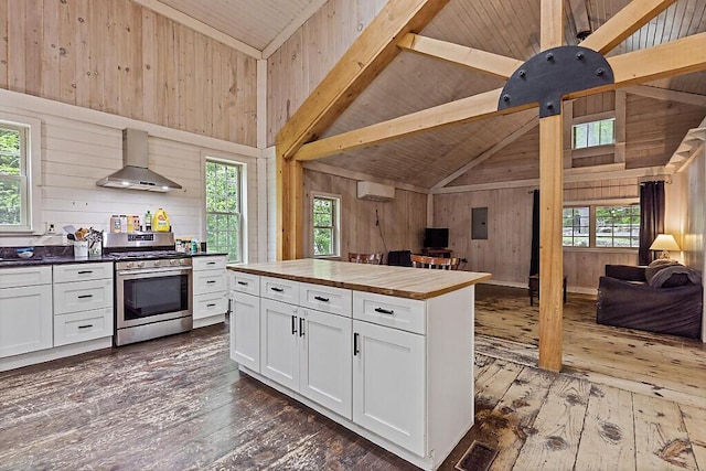 16 Trillium Ests, Rome, ME 04963 - kitchen featuring wall chimney range hood, stainless steel range with gas cooktop, open floor plan, butcher block counters, and a wall mounted air conditioner