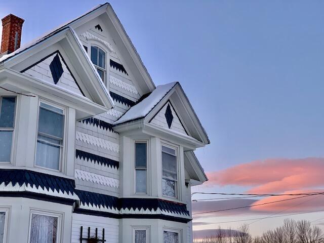 1 Forest St, Dover-Foxcroft, ME 04426 - property exterior at dusk with a chimney