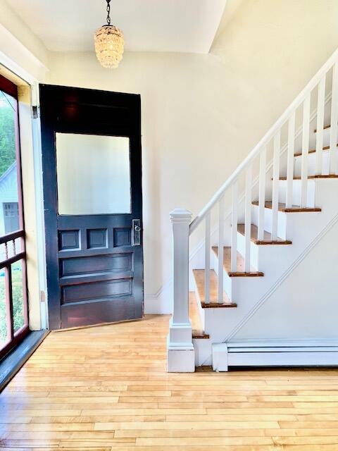 1 Forest St, Dover-Foxcroft, ME 04426 - entrance foyer featuring hardwood / wood-style flooring, stairway, and baseboard heating